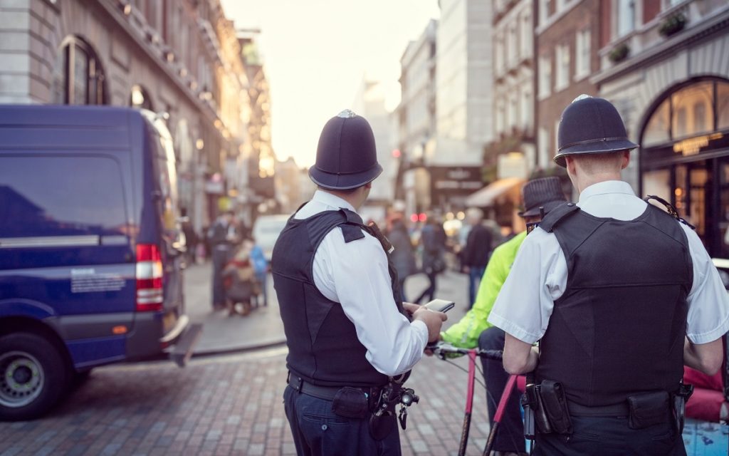 British police officers in helmets policing London streets. Image: Brian Jackson, Adobe stock