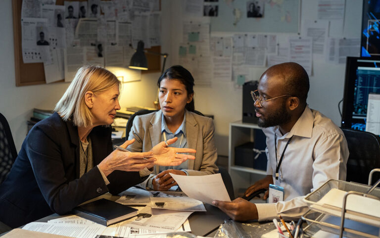 Group of investigators having a conversation in the workplace