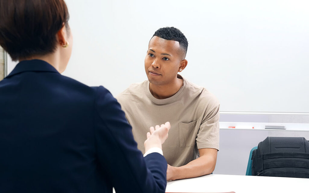 Two people sat at a table in an interview