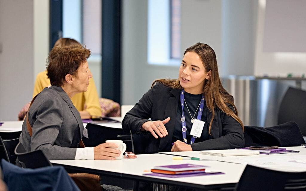 Two people speaking at an event workshop