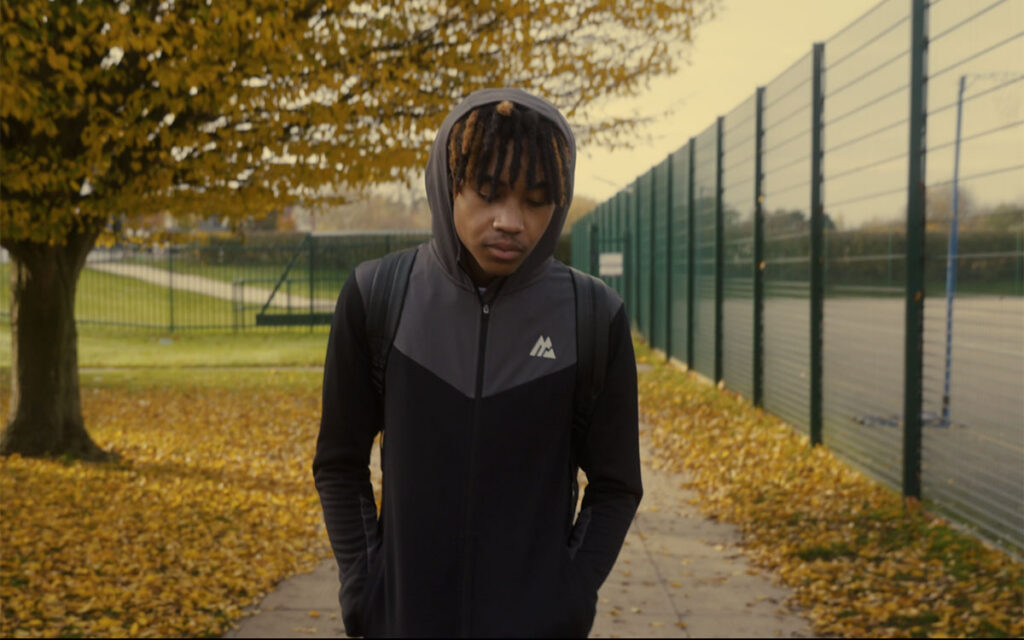 Teenager walking on a park path